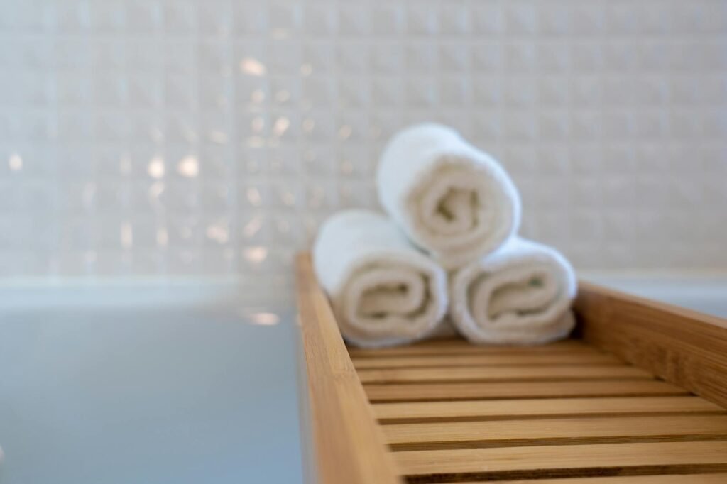 three towels on brown wooden rack